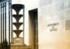 Department of Justice building exterior with sign and metal sculpture