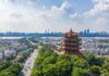 Yellow Crane Tower overlooking a modern city skyline and river