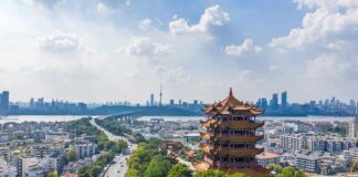 Yellow Crane Tower overlooking a modern city skyline and river