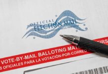Official election mail envelope with pen