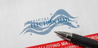 Official election mail envelope with pen