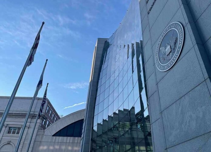 shutterstock_2063079581 Glass-fronted government building with seal and flagpoles