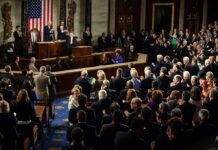 Billionaire Tax Bombshell Powers 2028 Play Legislators give a standing ovation in a grand chamber