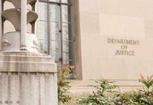 Justice Department Independence Under Fire Department of Justice building facade with stone sign and window