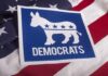 Democrats donkey symbol on a blue sign over an American flag