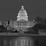 United States Capitol building at night with dome illuminated