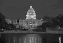 United States Capitol building at night with dome illuminated