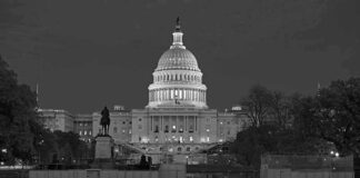 United States Capitol building at night with dome illuminated