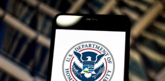 U.S. Department of Homeland Security logo on smartphone.