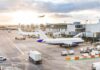 Cockpit Brawl Triggers Terrifying Midair Detour Airplanes at airport gates during sunset with ground vehicles and jet bridges