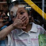 Quiet Memo Bottlenecks Child Rescue child behind a window raises hand to face
