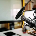 Podcast microphone with pop filter on desk