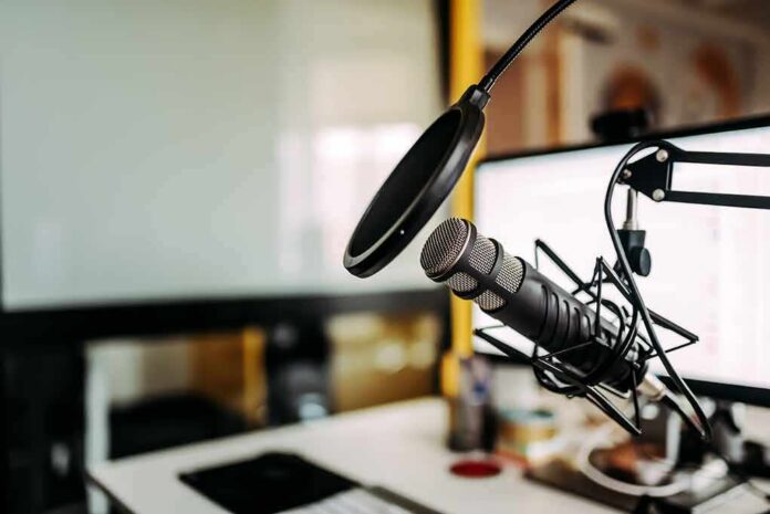 Podcast microphone with pop filter on desk