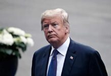 Russian Money Shadows Trump Jr. Wedding man in a suit with an American flag pin