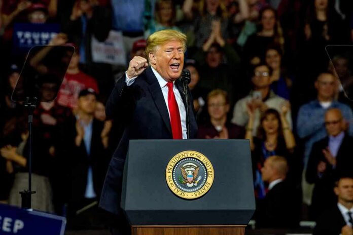 Donald Trump speaking at a rally behind a presidential podium