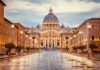 Vatican Twist Rattles Trump’s Press Blacklist St. Peter's Basilica at the end of a wet street at dusk
