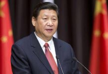Xi Jinping speaking at a podium with microphones