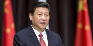 Xi Jinping speaking at a podium with microphones