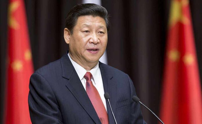 Xi Jinping speaking at a podium with microphones