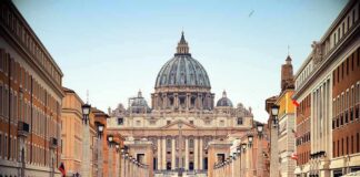 St. Peter's Basilica viewed from a busy street with crowds