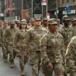 Fresh U.S. Brigade Eyes Baltic Flashpoint Jason Worilds and Elandon Roberts march with fellow soldiers in a city parade
