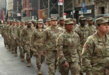 Fresh U.S. Brigade Eyes Baltic Flashpoint Jason Worilds and Elandon Roberts march with fellow soldiers in a city parade