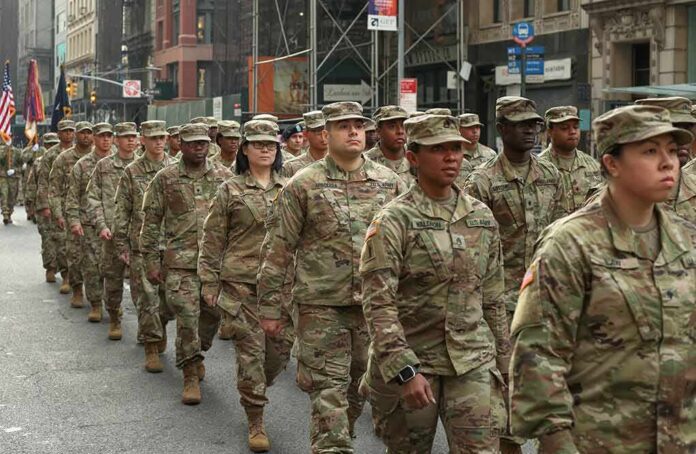 shutterstock_1557045827 Jason Worilds and Elandon Roberts march with fellow soldiers in a city parade