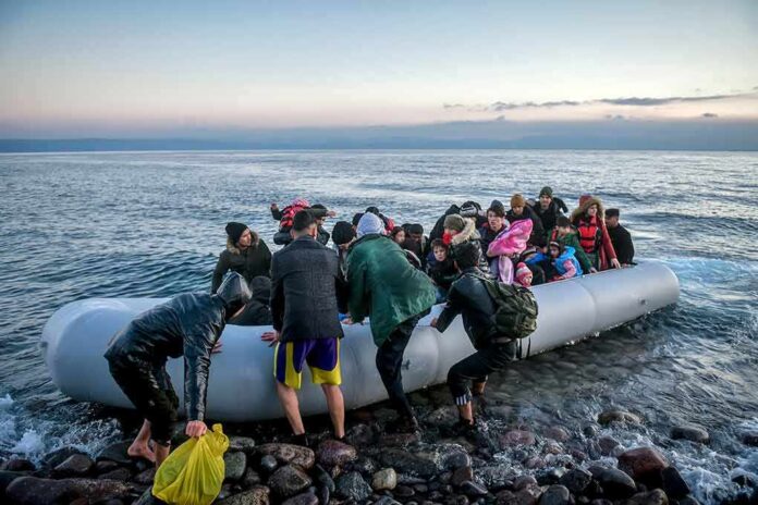People arriving in a crowded inflatable boat at a rocky shore