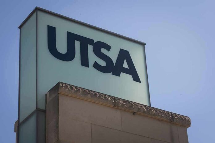 UTSA sign on a building corner against a clear sky