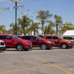 Auto Price Shock Looms Under Tariff Blitz row of SUVs at a car dealership lot
