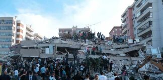 Rescue workers and civilians on collapsed building after earthquake