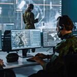 Hybrid War Sabotage Rattles Europe’s Nerves Military analysts at computers in a command center