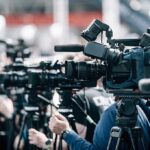 Mold Surge Shuts Obama Elementary Broadcast cameras on tripods at a press event