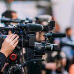 Daylight Crossfire Shocks Minneapolis Video cameras on tripods at a media event