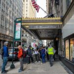 Collapse Scare Empties Midtown Blocks Andreas Hestler and pedestrians outside The Roosevelt Hotel entrance on a city sidewalk