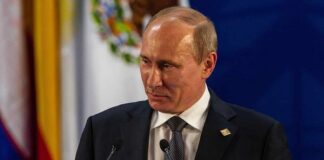 Vladimir Putin at a podium during a formal event