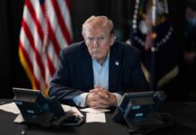 Trump Centralizes Services Under One AI Donald Trump seated at a table between two desk phones