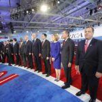 Chris Christie stands at right as Carly Fiorina, Jeb Bush, Ben Carson, and John Kasich line up on a debate stage