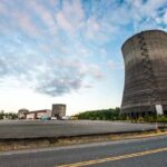 Nuclear Near-Miss Stuns Watchdog Cooling towers at an industrial power plant under a partly cloudy sky