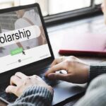 Person using a laptop to search for scholarships