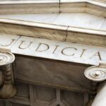 Offshore Web Cracks—Mafia Fortune Grabbed Courthouse facade with stone columns and entablature