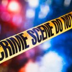 Off-Duty ICE Chaos Ends In Gunfire yellow crime scene tape with blurred police lights