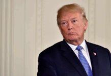 Trump Axes Execution Broadcast After Bipartisan Fury Donald Trump in a dark suit with blue tie looking to the side
