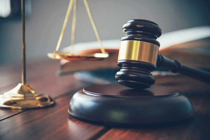 Judge's gavel on block with scales of justice