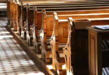 wooden church pews in sunlight
