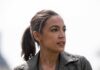 woman in a leather jacket looking to the side