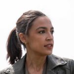 woman in a leather jacket looking to the side