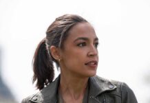 woman in a leather jacket looking to the side