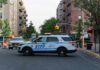 Queens Horror: Mask, Gunfire, Vanished Motive NYPD police SUV blocking a city street at a taped-off scene