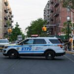 Queens Horror: Mask, Gunfire, Vanished Motive NYPD police SUV blocking a city street at a taped-off scene